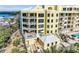 Stunning multi-story building with multiple balconies offering scenic views, as well as a pool and patio area at 9122 Midnight Pass Rd # 24, Sarasota, FL 34242