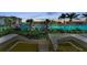 Stairway leading down to the scenic waterfront with views of the marina, palm trees, and clear blue water at 9122 Midnight Pass Rd # 24, Sarasota, FL 34242