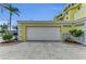 Attached two car garage with automatic door and neutral painted siding at 9122 Midnight Pass Rd # 24, Sarasota, FL 34242