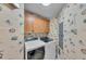 A laundry room with modern washer and dryer units with whimsical wallpaper at 9122 Midnight Pass Rd # 24, Sarasota, FL 34242