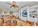 Open concept living space includes custom built ins, comfortable seating, and view to dining at 9122 Midnight Pass Rd # 24, Sarasota, FL 34242