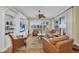 Inviting living room with built-in shelving, ceiling fan, and plenty of natural light at 9122 Midnight Pass Rd # 24, Sarasota, FL 34242