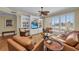 Spacious living room featuring comfortable seating, stylish decor, and large windows at 9122 Midnight Pass Rd # 24, Sarasota, FL 34242