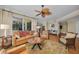 Cozy living room with hardwood floors, a ceiling fan, and access to an outdoor deck at 9122 Midnight Pass Rd # 24, Sarasota, FL 34242