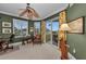 Well-lit office with a ceiling fan, plantation shutters, and a private balcony at 9122 Midnight Pass Rd # 24, Sarasota, FL 34242