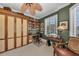 This office features built-in shelving, plantation shutters, and a ceiling fan at 9122 Midnight Pass Rd # 24, Sarasota, FL 34242