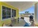 Outdoor patio with dining table and chairs featuring ocean views and a grill for barbecuing at 9122 Midnight Pass Rd # 24, Sarasota, FL 34242