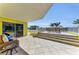 Spacious outdoor patio with elegant seating and ocean views on a clear day at 9122 Midnight Pass Rd # 24, Sarasota, FL 34242