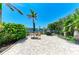 Outdoor patio features brick pavers, furniture, barbeque grill and view of waterway at 9122 Midnight Pass Rd # 24, Sarasota, FL 34242