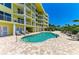 Inviting outdoor pool with lounge chairs, palm trees, and a well-maintained deck for ultimate relaxation and enjoyment at 9122 Midnight Pass Rd # 24, Sarasota, FL 34242