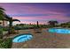 Beautiful outdoor pool and hot tub area with comfortable seating and lush landscaping, perfect for relaxation at 9122 Midnight Pass Rd # 24, Sarasota, FL 34242