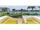 Inviting waterfront view from the property with boat docks, serene waters, and lush tropical foliage at 9122 Midnight Pass Rd # 24, Sarasota, FL 34242
