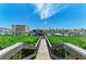 Scenic water view with lush greenery leading to boat docks, under a bright sky, showcasing the waterfront property at 9122 Midnight Pass Rd # 24, Sarasota, FL 34242