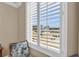 View from window with white shutters overlooking the neighborhood and blue skies above at 9122 Midnight Pass Rd # 24, Sarasota, FL 34242