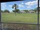 Screened lanai view showcasing serene golf course and neighborhood at 4906 Peridia E Blvd, Bradenton, FL 34203