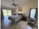 Bright bedroom with sliding glass doors leading to a patio and an accent chair at 4906 Peridia E Blvd, Bradenton, FL 34203