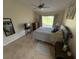 Bedroom with a sliding door to the patio, a ceiling fan, and bright natural light at 4906 Peridia E Blvd, Bradenton, FL 34203
