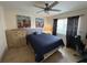 Comfortable bedroom featuring a ceiling fan and bright natural light from the window at 4906 Peridia E Blvd, Bradenton, FL 34203