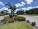 Scenic community entrance featuring lush landscaping, palm trees, and a well-maintained road at 4906 Peridia E Blvd, Bradenton, FL 34203