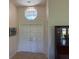 Inviting foyer with double doors, high ceilings, and decorative window at 4906 Peridia E Blvd, Bradenton, FL 34203