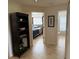 Hallway that accesses the bedroom and bathroom, has a bookcase, and tile flooring at 4906 Peridia E Blvd, Bradenton, FL 34203