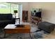 Comfortable living room with a sectional sofa, wooden coffee table, and entertainment center at 4906 Peridia E Blvd, Bradenton, FL 34203