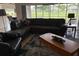 Comfortable living room with sectional seating, a wood table, and outdoor view at 4906 Peridia E Blvd, Bradenton, FL 34203