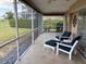 Relaxing screened lanai with comfortable seating, stylish tile, and private backyard at 4906 Peridia E Blvd, Bradenton, FL 34203