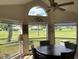 Bright sunroom featuring lots of windows, a ceiling fan and a table with chairs at 4906 Peridia E Blvd, Bradenton, FL 34203