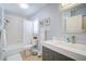 Bright bathroom features a vanity with a white countertop and a combined tub and shower at 7251 Sunnybrook Blvd, Englewood, FL 34224