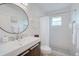 Modern bathroom with a sleek vanity, updated fixtures, and a walk-in shower at 7251 Sunnybrook Blvd, Englewood, FL 34224