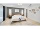 Bedroom with a wood bed frame, sliding glass doors, and gray accent wall at 7251 Sunnybrook Blvd, Englewood, FL 34224