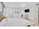Bright bedroom boasts white walls, wood floors, and stylish wall decorations at 7251 Sunnybrook Blvd, Englewood, FL 34224