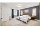 Light and airy bedroom featuring hardwood floors, a gray accent wall, and sliding glass doors at 7251 Sunnybrook Blvd, Englewood, FL 34224