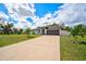 Beautiful home exterior with a manicured lawn and a long driveway at 7251 Sunnybrook Blvd, Englewood, FL 34224