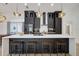 Modern kitchen features an island, updated appliances, and custom black cabinets with gold hardware at 7251 Sunnybrook Blvd, Englewood, FL 34224