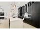 Modern kitchen features an island, updated appliances, and custom black cabinets with gold hardware at 7251 Sunnybrook Blvd, Englewood, FL 34224