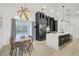 Stylish kitchen with black cabinets, stainless steel appliances, and an island with barstool seating at 7251 Sunnybrook Blvd, Englewood, FL 34224
