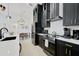 Modern kitchen features updated appliances, custom black cabinets with gold hardware and eat in area at 7251 Sunnybrook Blvd, Englewood, FL 34224