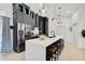 Modern kitchen with dark cabinetry, a large white island, and stainless-steel appliances at 7251 Sunnybrook Blvd, Englewood, FL 34224