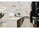 Spacious modern kitchen with a large island, dark cabinetry, and a view into the adjacent living room at 7251 Sunnybrook Blvd, Englewood, FL 34224