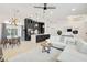 Open-concept living space with a white sofa, modern kitchen, and dining area at 7251 Sunnybrook Blvd, Englewood, FL 34224