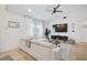 Comfortable living room with a large sectional sofa, modern decor, and natural light at 7251 Sunnybrook Blvd, Englewood, FL 34224