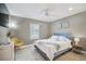 Cozy main bedroom with a blue upholstered headboard, neutral décor, and a ceiling fan at 7251 Sunnybrook Blvd, Englewood, FL 34224