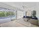 Relaxing screened-in patio with comfortable seating overlooking a pool and lush greenery at 7251 Sunnybrook Blvd, Englewood, FL 34224