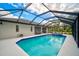 Sparkling pool and spa surrounded by a screened enclosure, perfect for outdoor enjoyment and privacy at 7251 Sunnybrook Blvd, Englewood, FL 34224