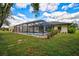 Enjoy the screened-in pool and spa, ideal for relaxing in privacy, surrounded by a well-maintained backyard at 7251 Sunnybrook Blvd, Englewood, FL 34224