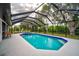 Spacious screened-in pool and patio area surrounded by lush landscaping at 7251 Sunnybrook Blvd, Englewood, FL 34224