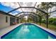 Sparkling pool and spa surrounded by a screened enclosure, perfect for outdoor enjoyment and relaxation at 7251 Sunnybrook Blvd, Englewood, FL 34224