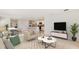 Spacious living room open to dining and kitchen areas, showcasing modern decor and an open-concept design at 10730 Hidden Banks Gln, Parrish, FL 34219